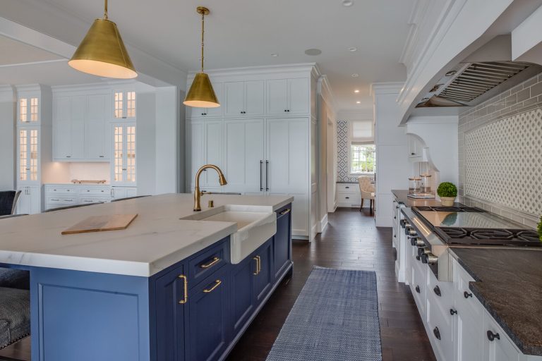 Kitchen Remodeling blue island with brass or brushed gold pendant lights.